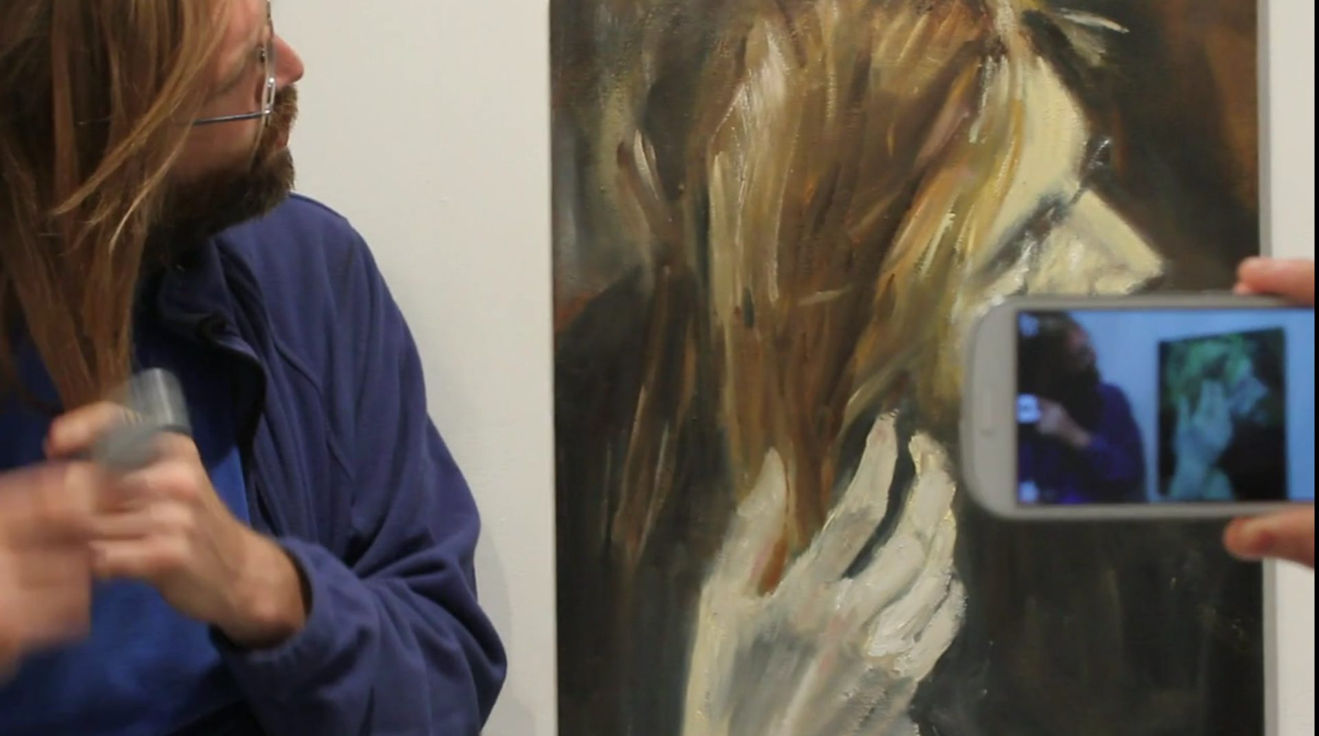A phone held in front of a painted figure during the Super Paintings augmented-reality project