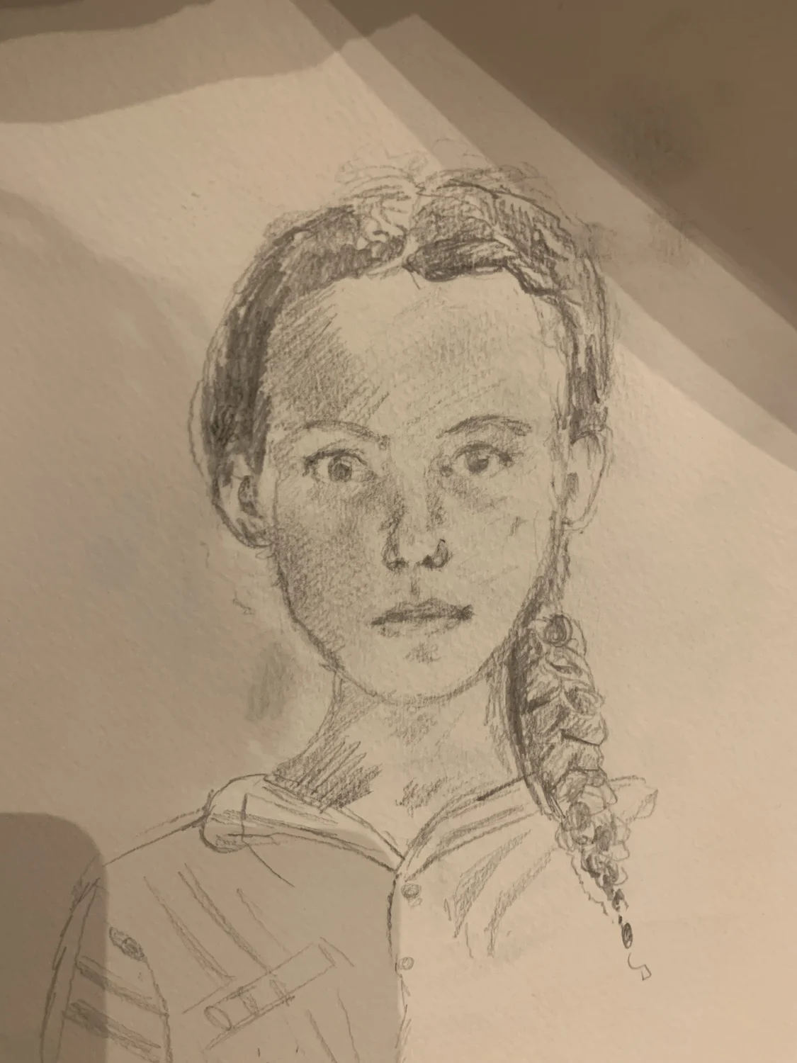 A pencil portrait drawn on folded paper