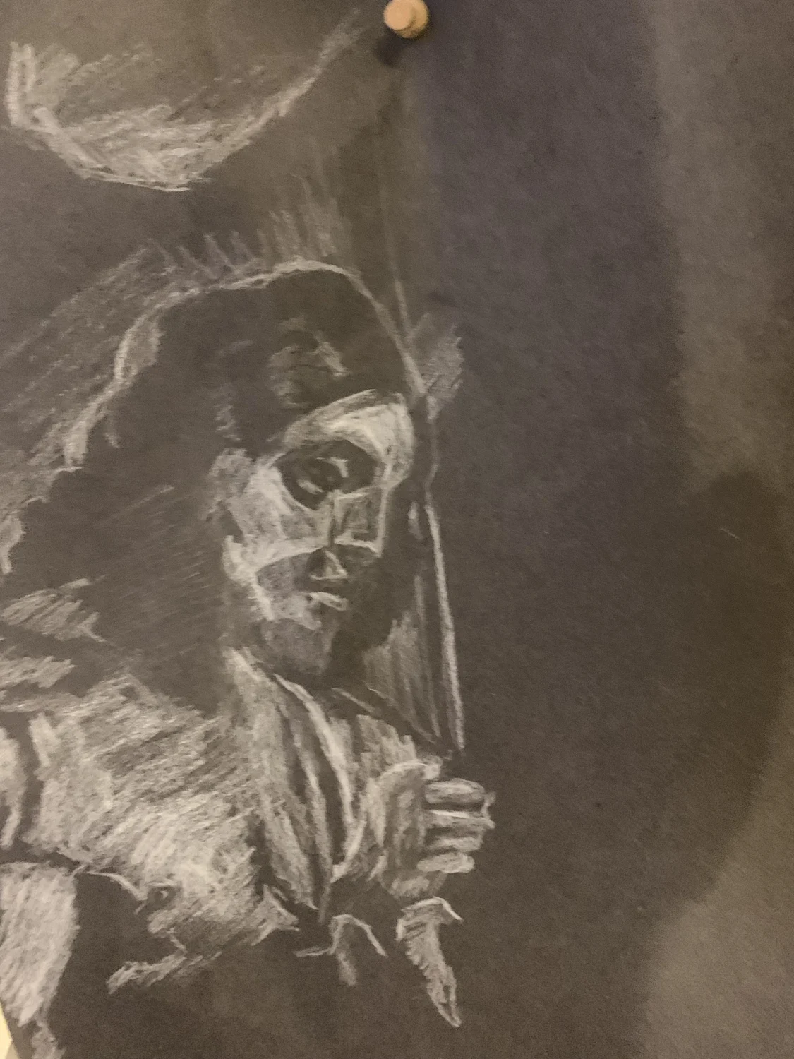 A portrait drawn in pale marks on dark paper