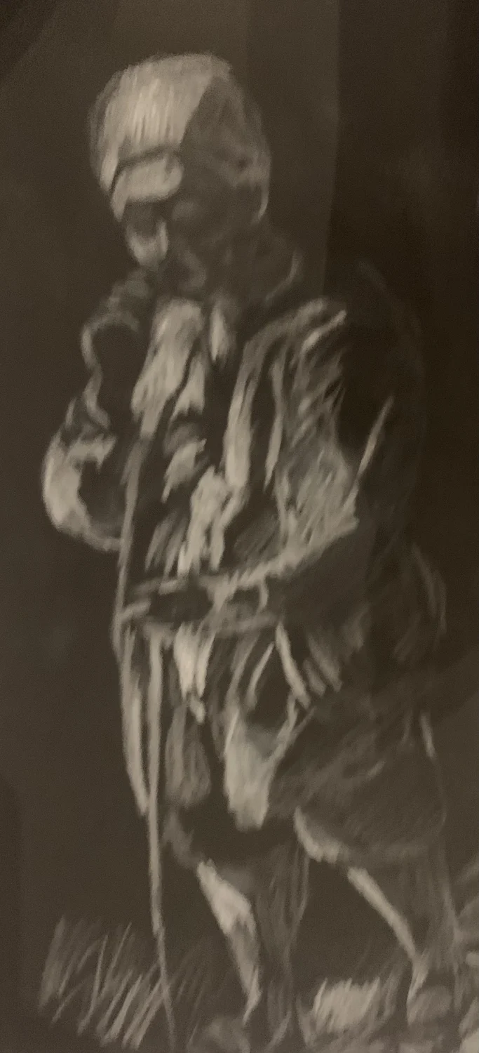 A seated figure drawn in pale marks on dark paper