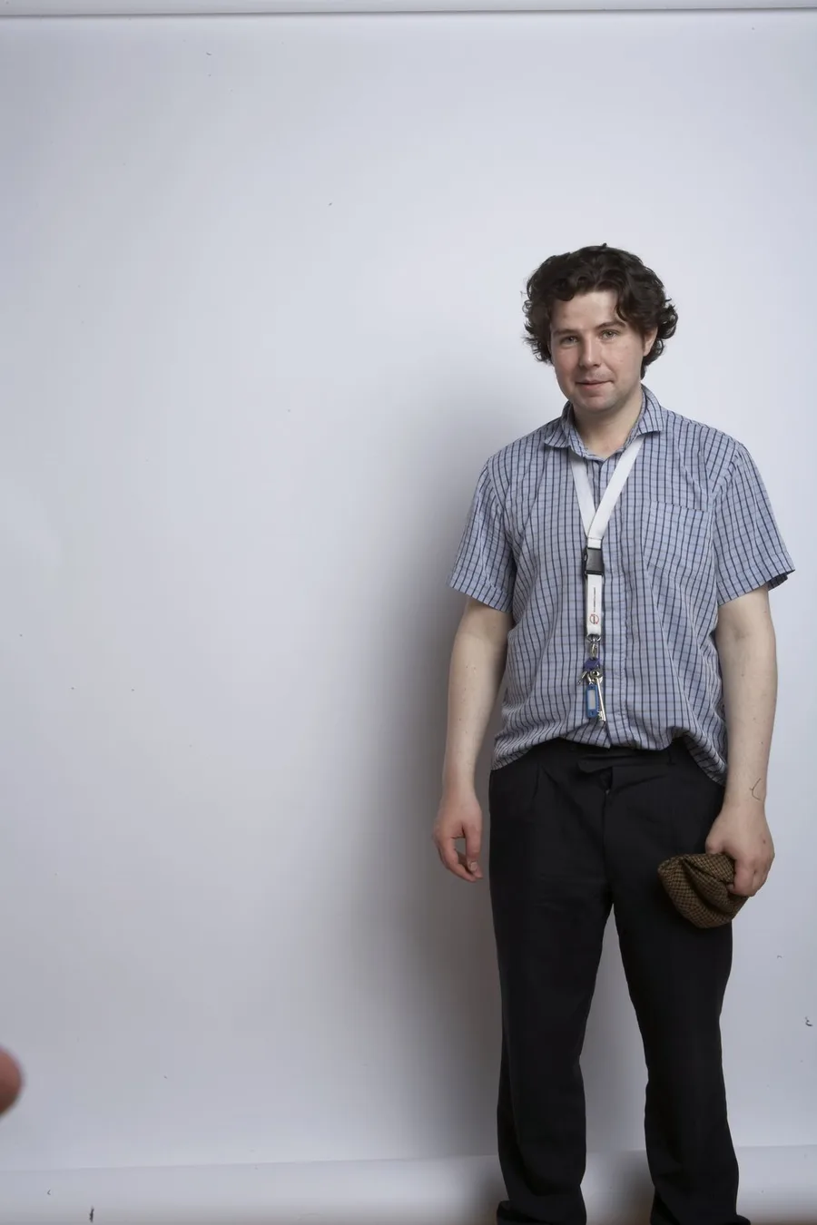 Jimmy Connelly standing against a pale studio backdrop