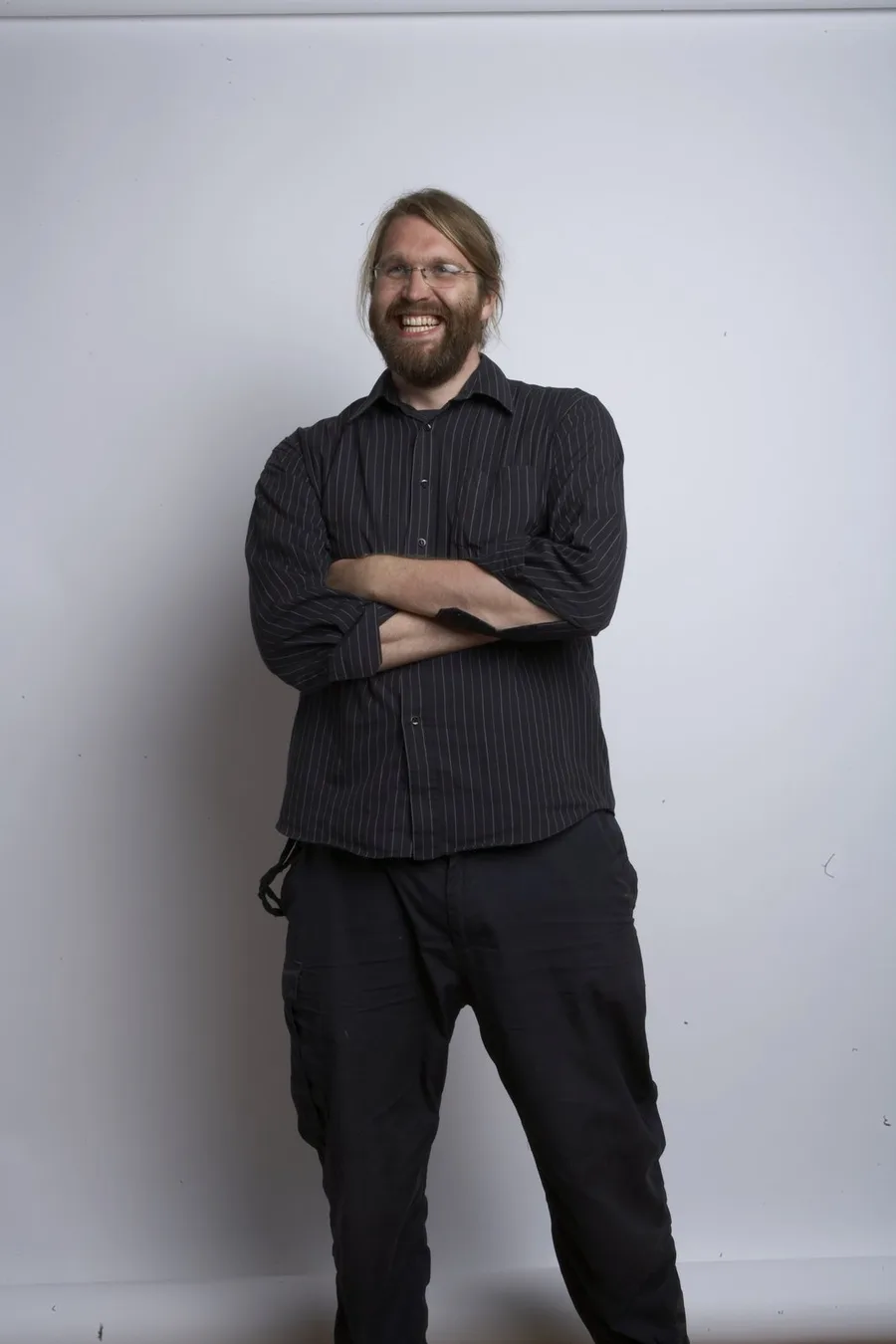Ollie Bancroft standing against a pale studio backdrop