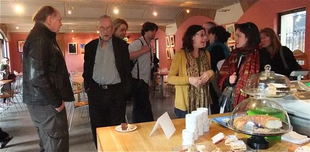 Visitors gathered around tables in the exhibition space