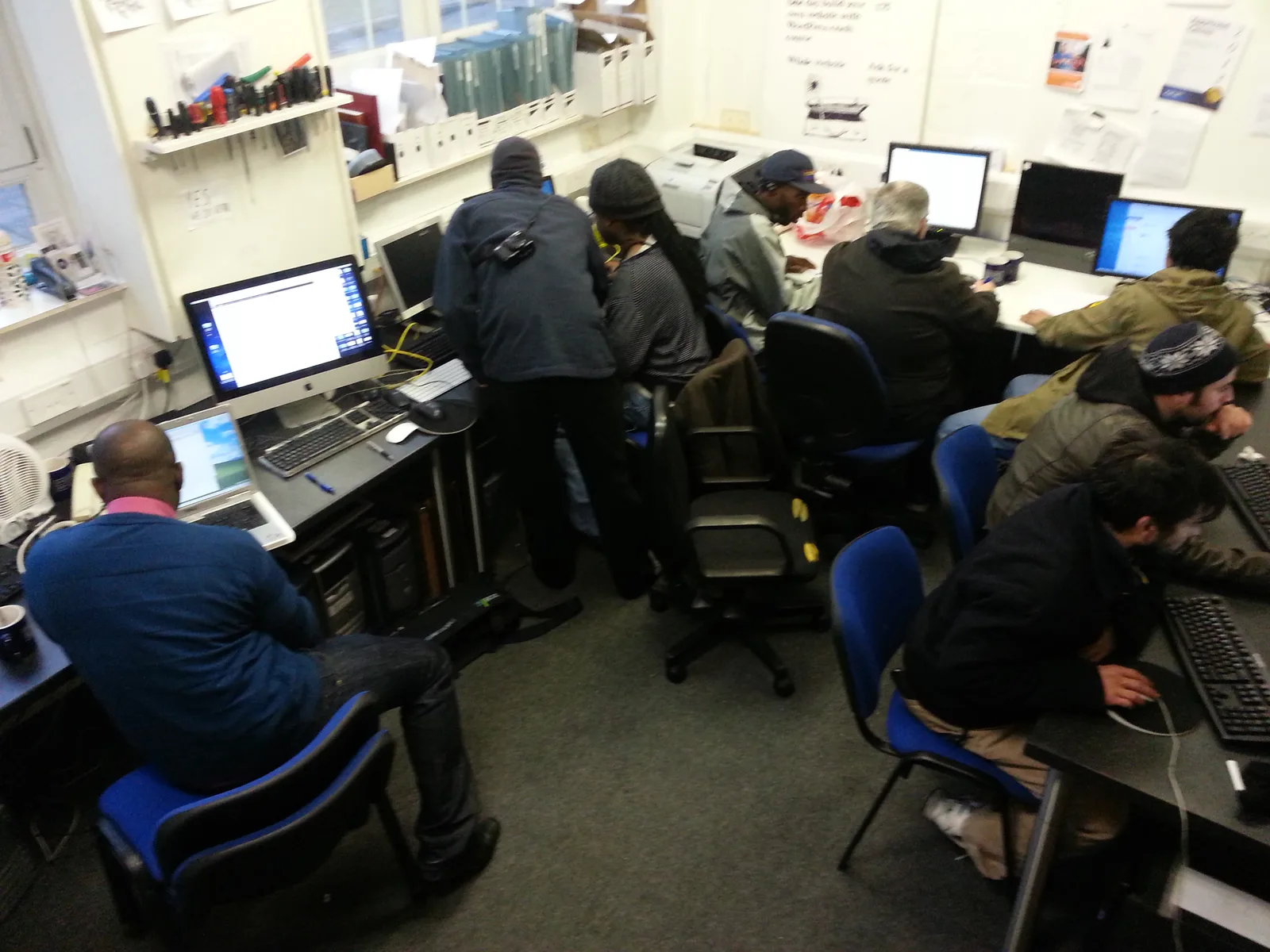 People working independently and together at computers during a Suitcase Media CIC drop-in day