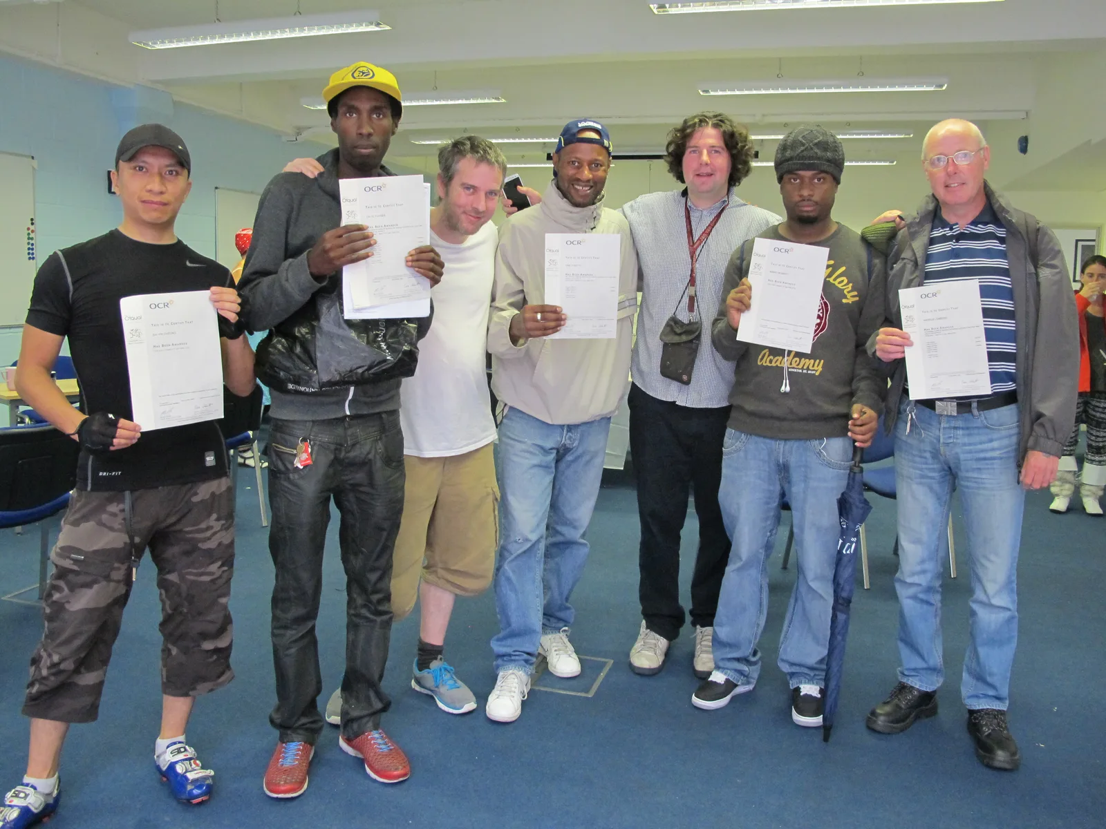 A group holding OCR certificates in a computer room